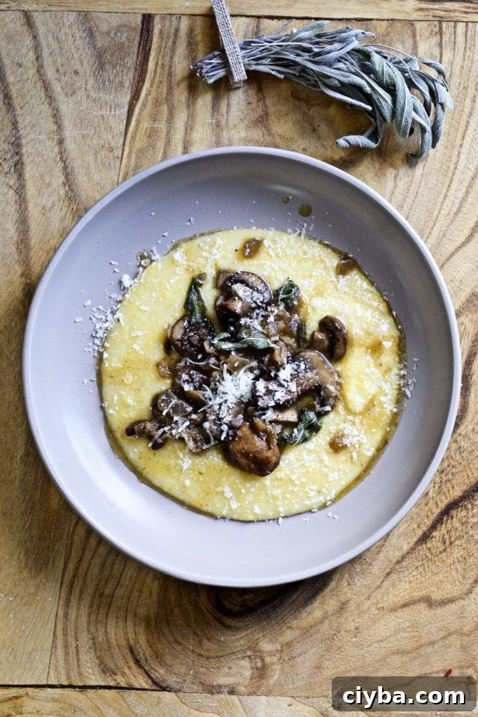 Plate of polenta and mushrooms with sage butter sauce.