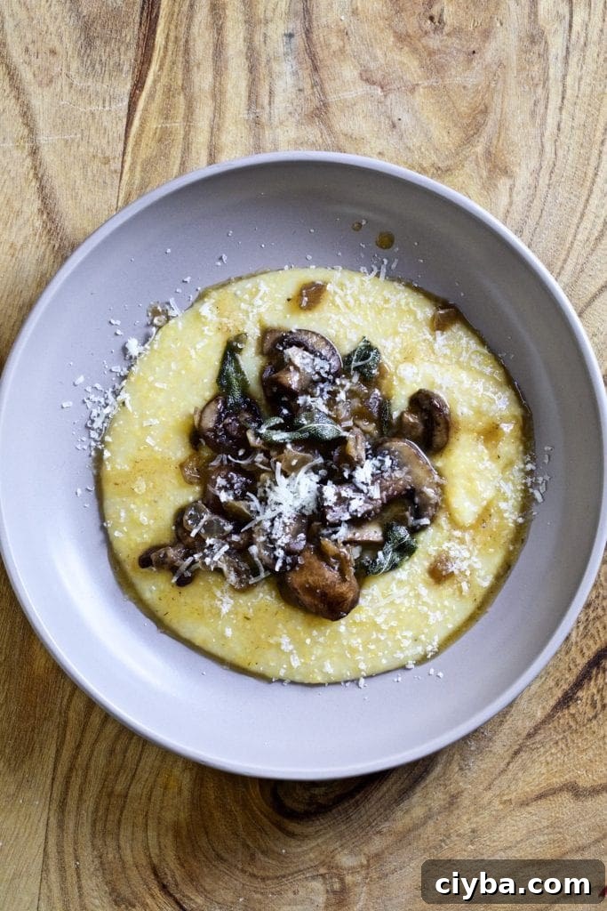 Plate of polenta and mushrooms with sage butter sauce.