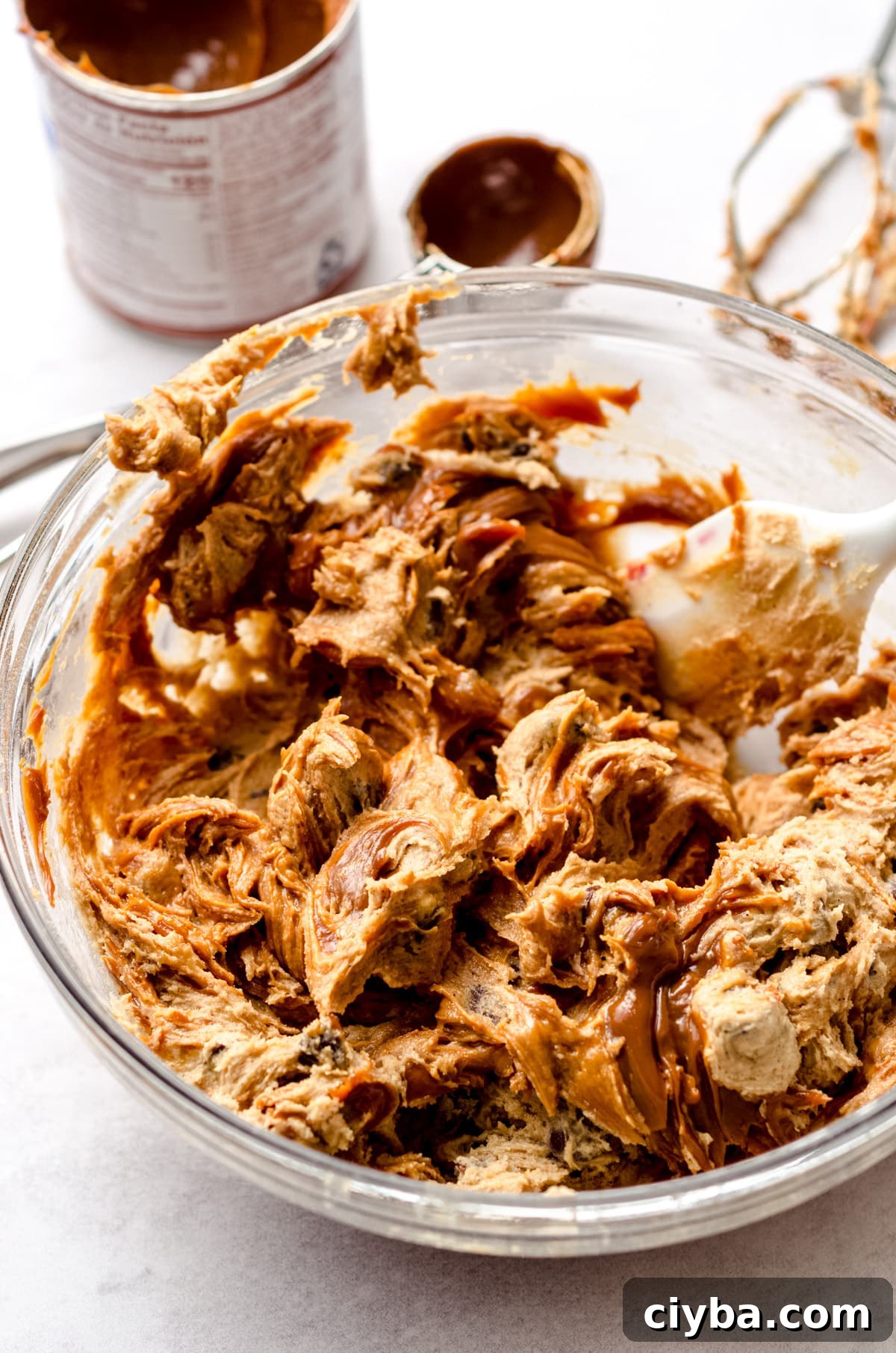 Swirling and mixing dulce de leche into a cookie dough.