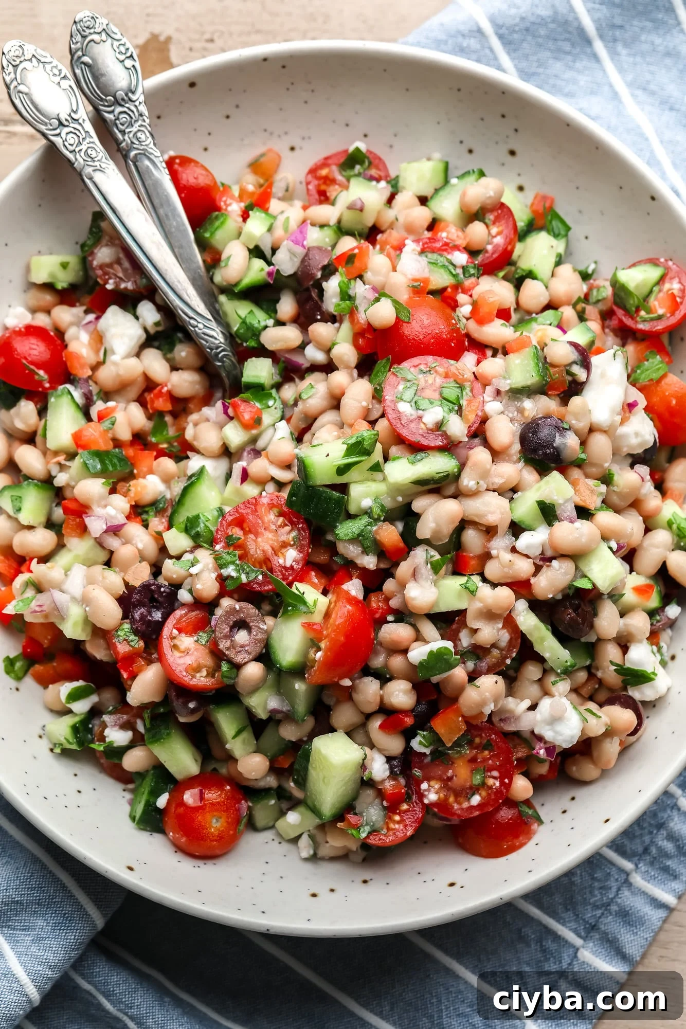 a Mediterranean white bean salad in a large white bowl.