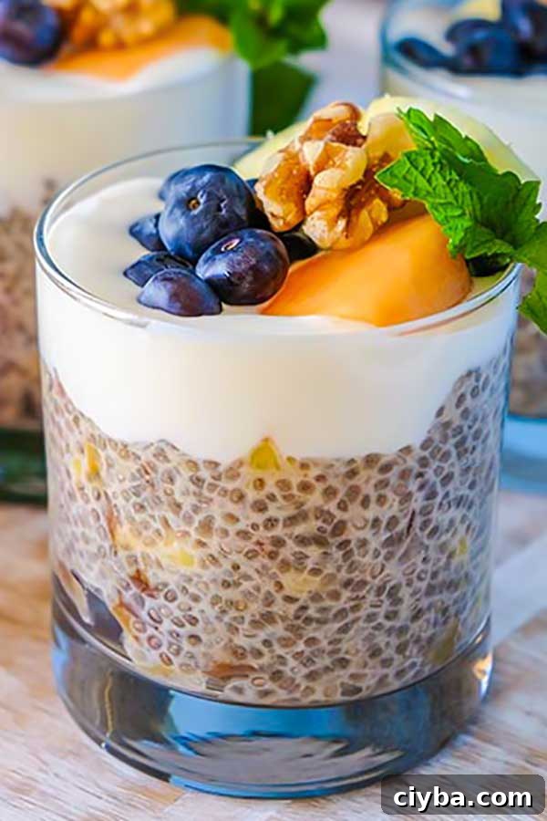 chia pudding with pineapple, dates in a cup and topped with walnuts and berries