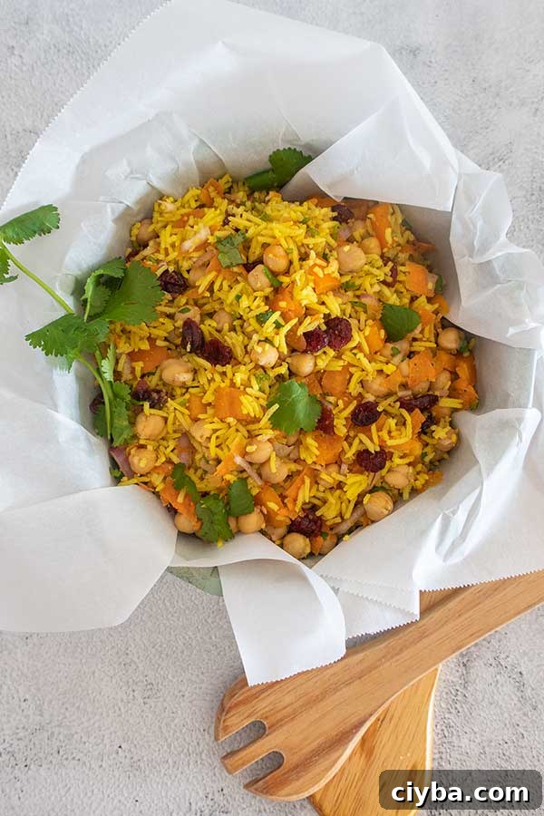 moroccan chickpea rice salad in a large salad bowl toped with cilantro