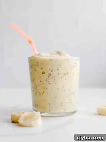A smoothie with an orange straw.