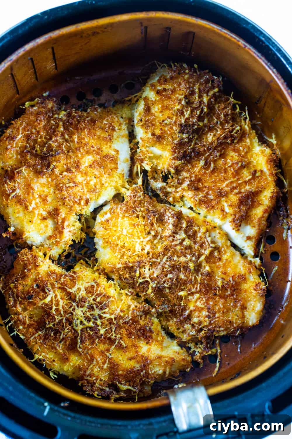 Crispy Parmesan-Crusted Chicken in the Air Fryer 3 Parmesan Chicken in an air fryer basket.