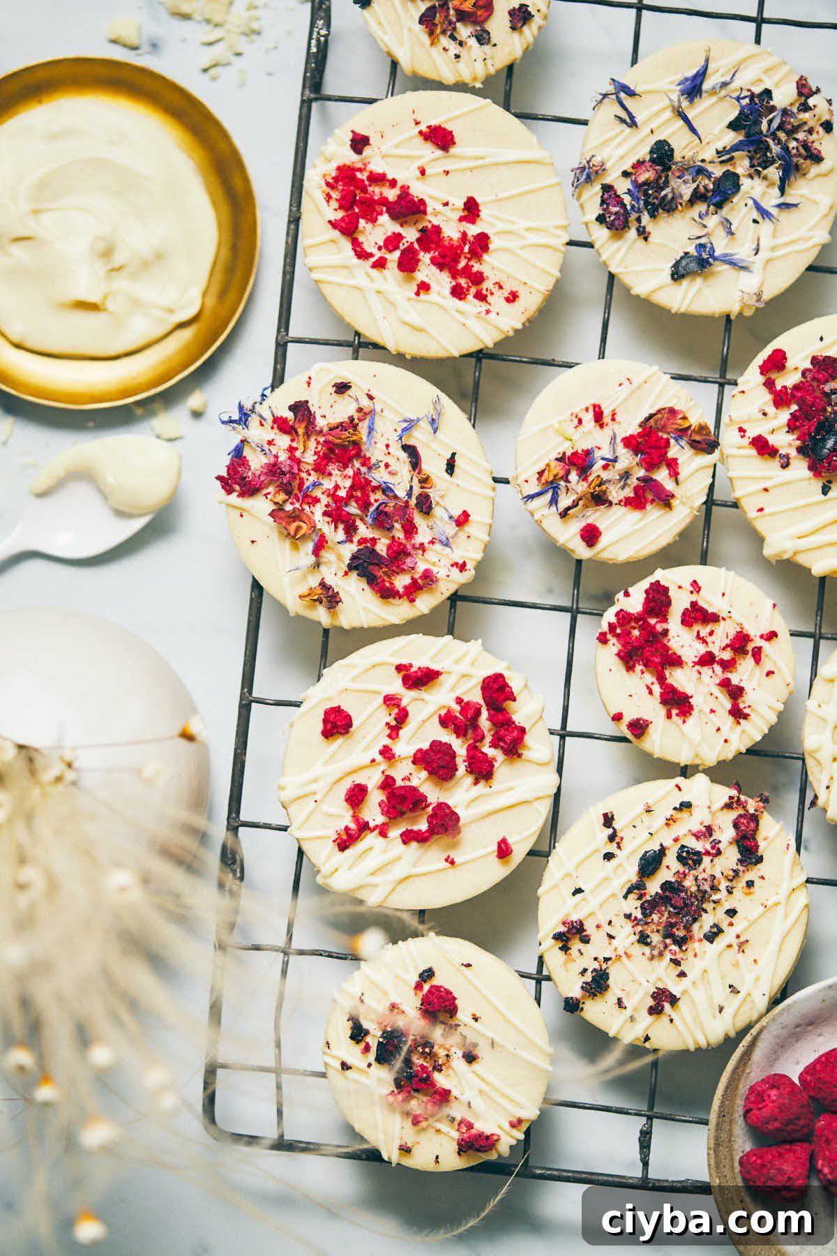 Cookies on a cooling rack after being iced