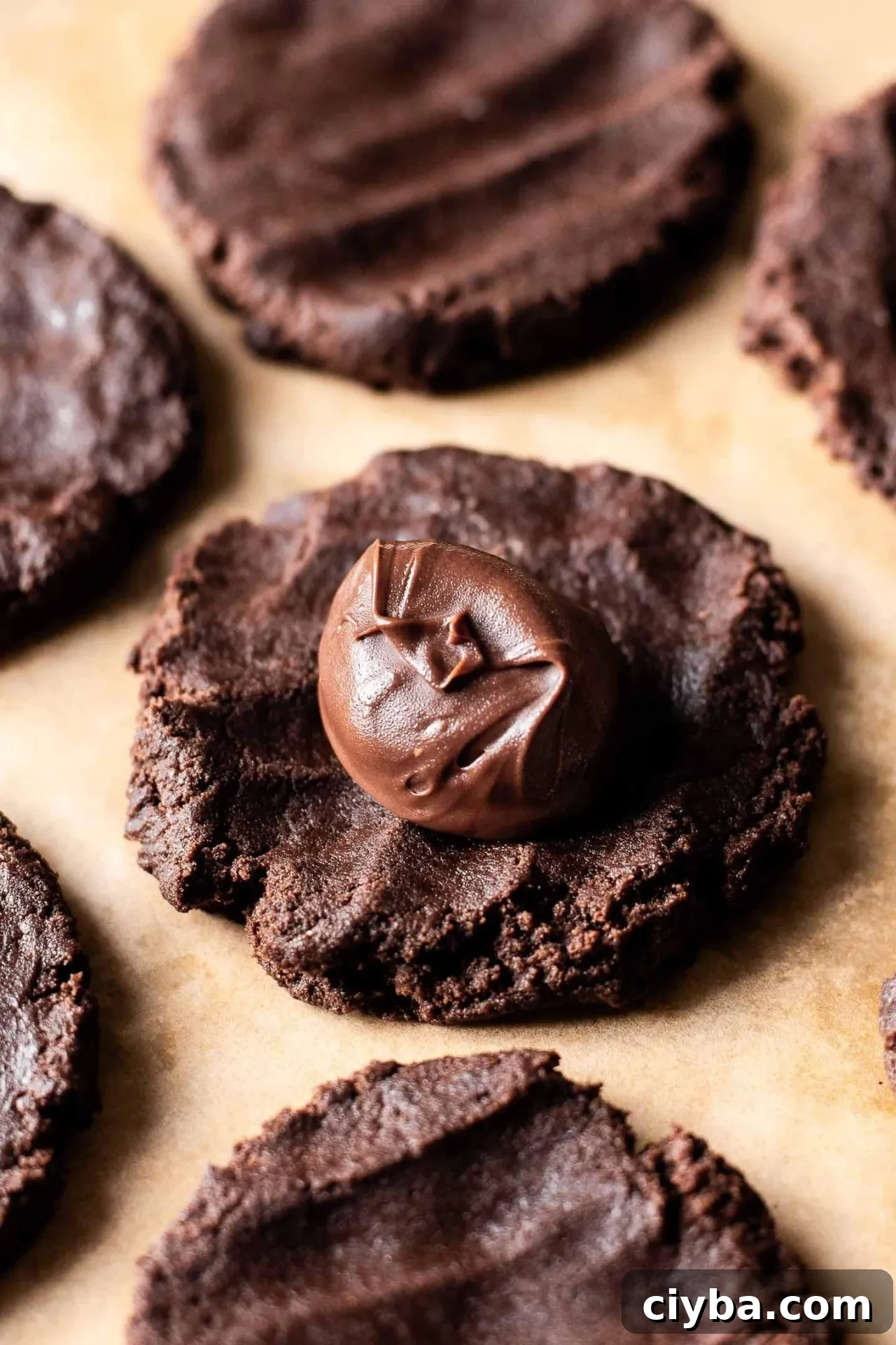 Nutella chocolate lava cookie dough ball flattened into a disk with Nutella ball places in center