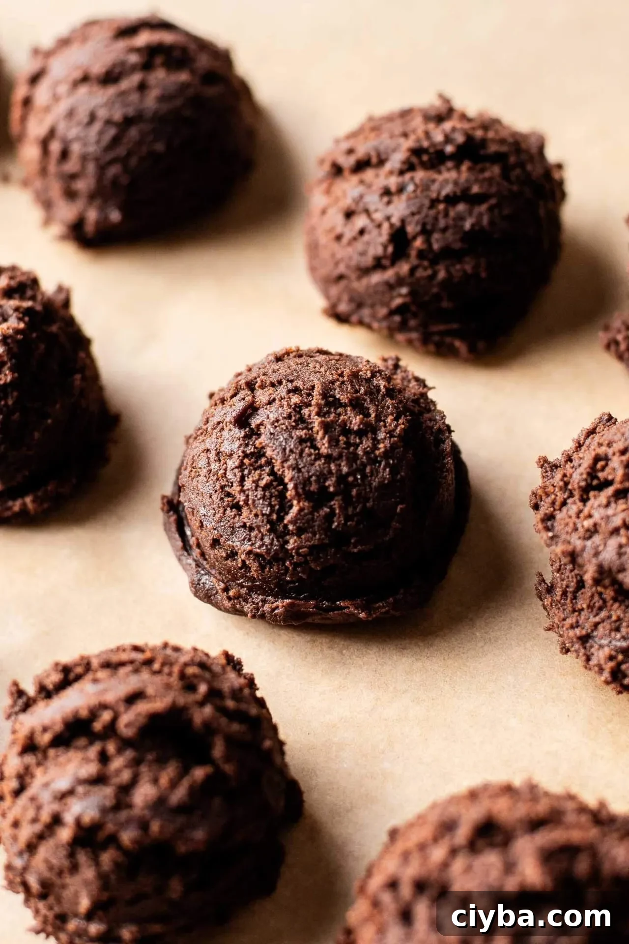 Nutella chocolate lava cookie dough scooped onto parchment lined baking sheet