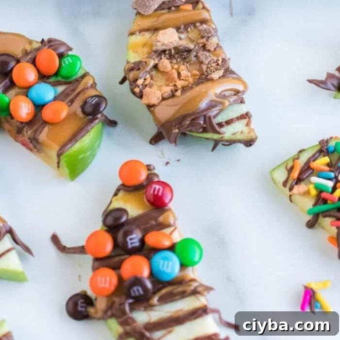 Caramel Apple Slices on table decorated with crushed candy and mini M&Ms