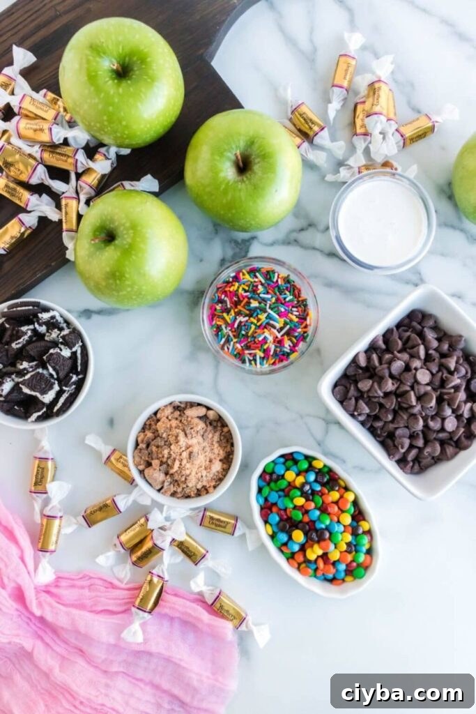 Caramel Apple ingredients on table in bowls: m&ms, chocoalte chips, sprinkles, crushed cookies, and more