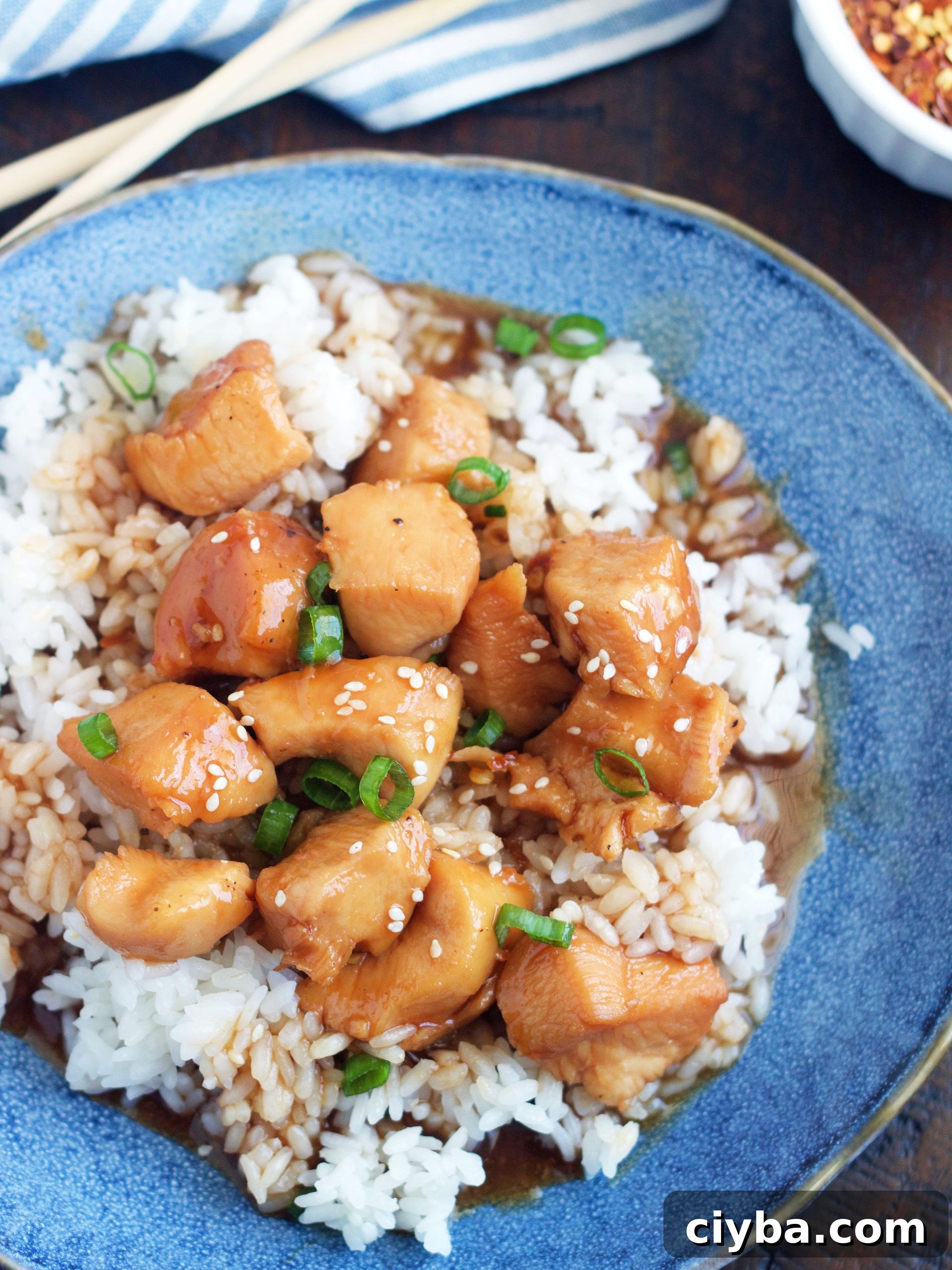 Plate of slow cooker honey sesame chicken over rice