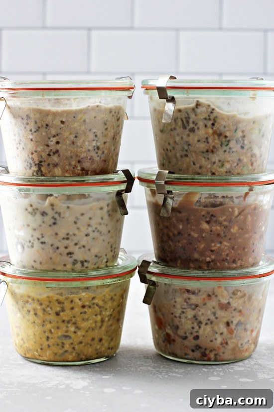 Six jars of oatmeal stacked on a grey surface.