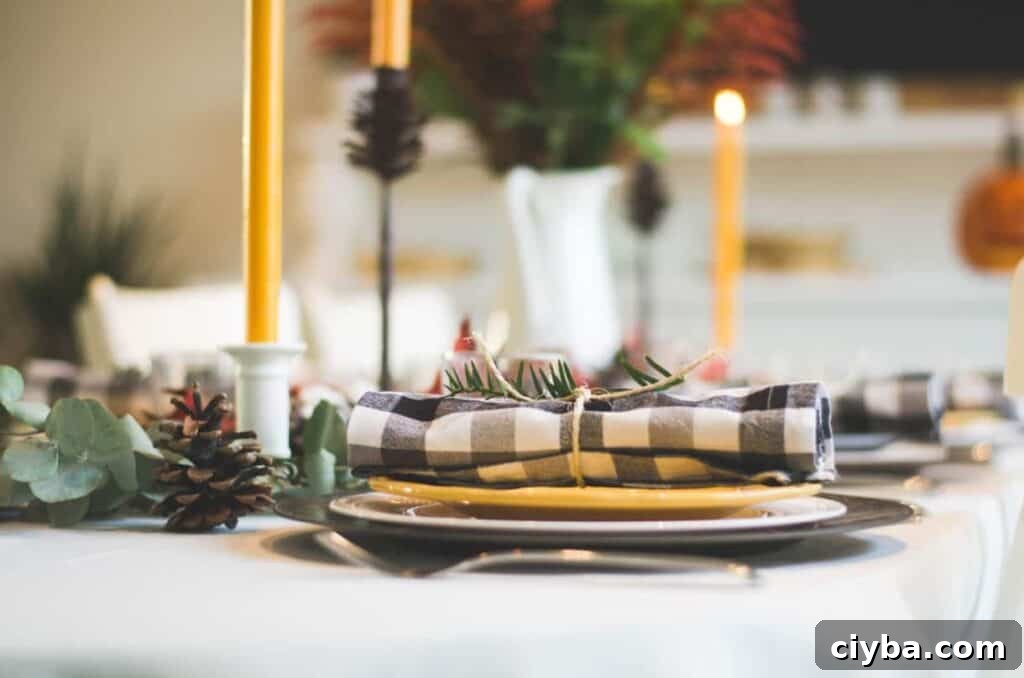 Photo by Libby Penner on Unsplash. Black and yellow holiday tablescape with Jack-o-lantern.