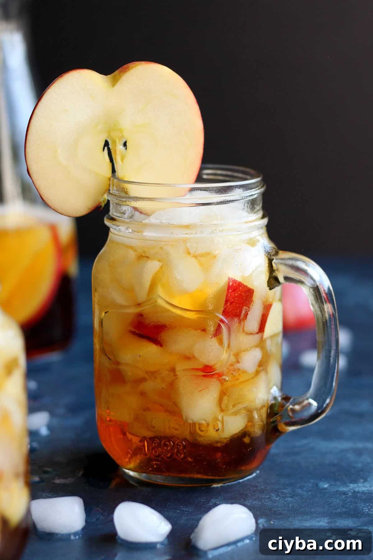 Autumn Pimm’s Cup Cocktail Recipe for Cozy Evenings 3 A pimm's cup cocktail garnish with a slice of apple.