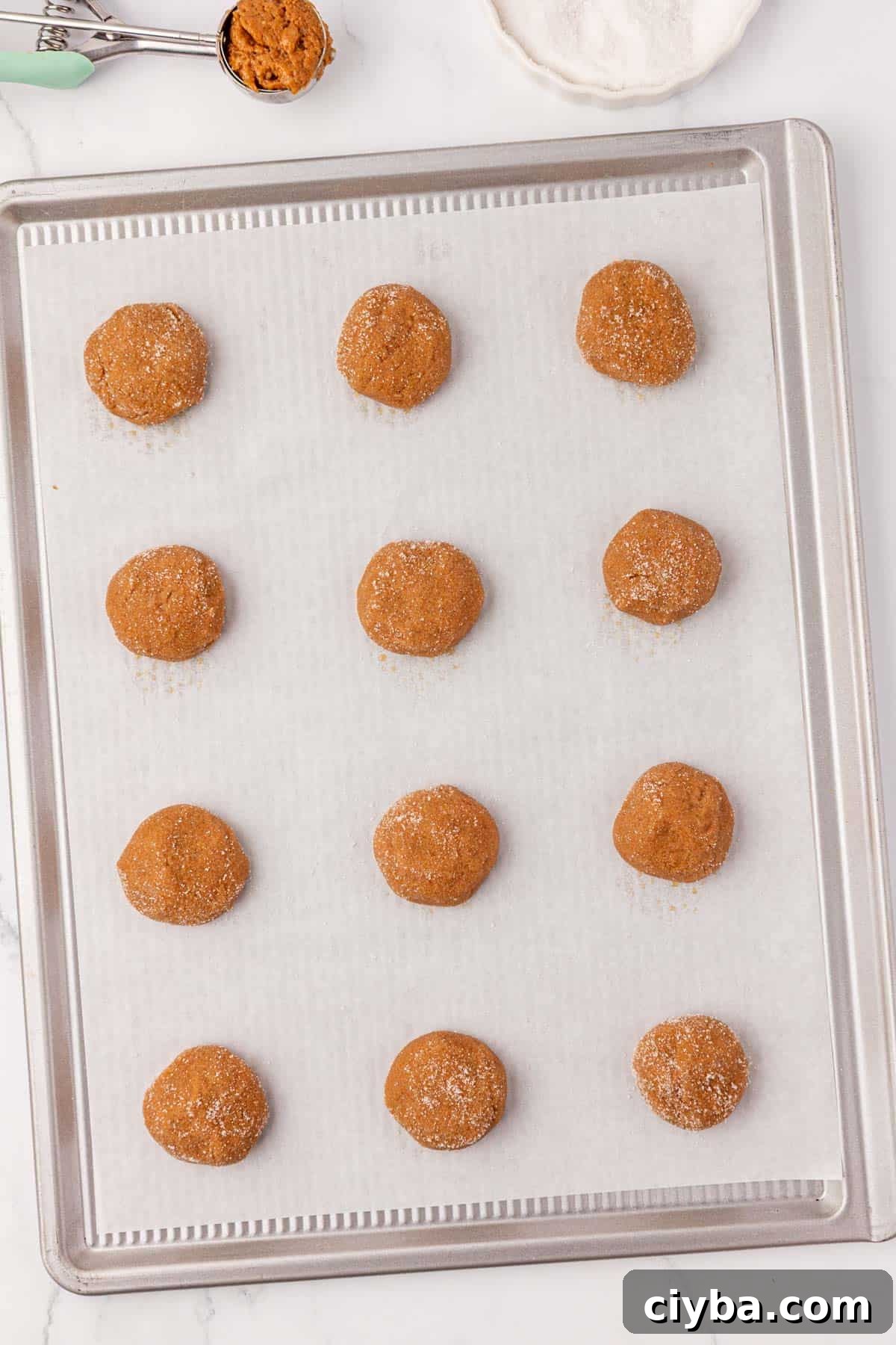 balls of cookie dough on a baking sheet