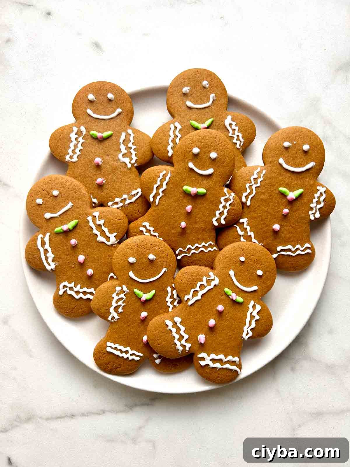 Classic Gingerbread Cookies Recipe for Soft, Spiced Cookies 2 plate of gingerbread cookies with icing.
