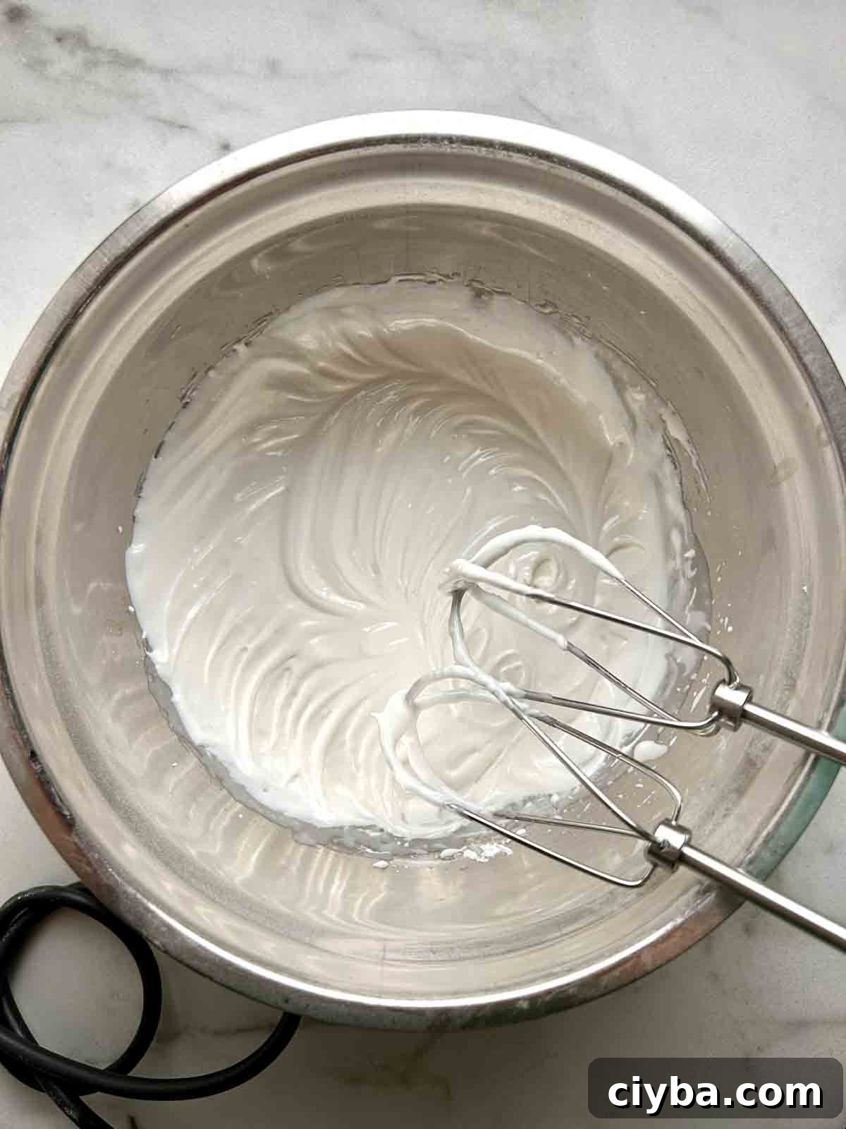 Classic Gingerbread Cookies Recipe for Soft, Spiced Cookies 11 icing being beaten in bowl.