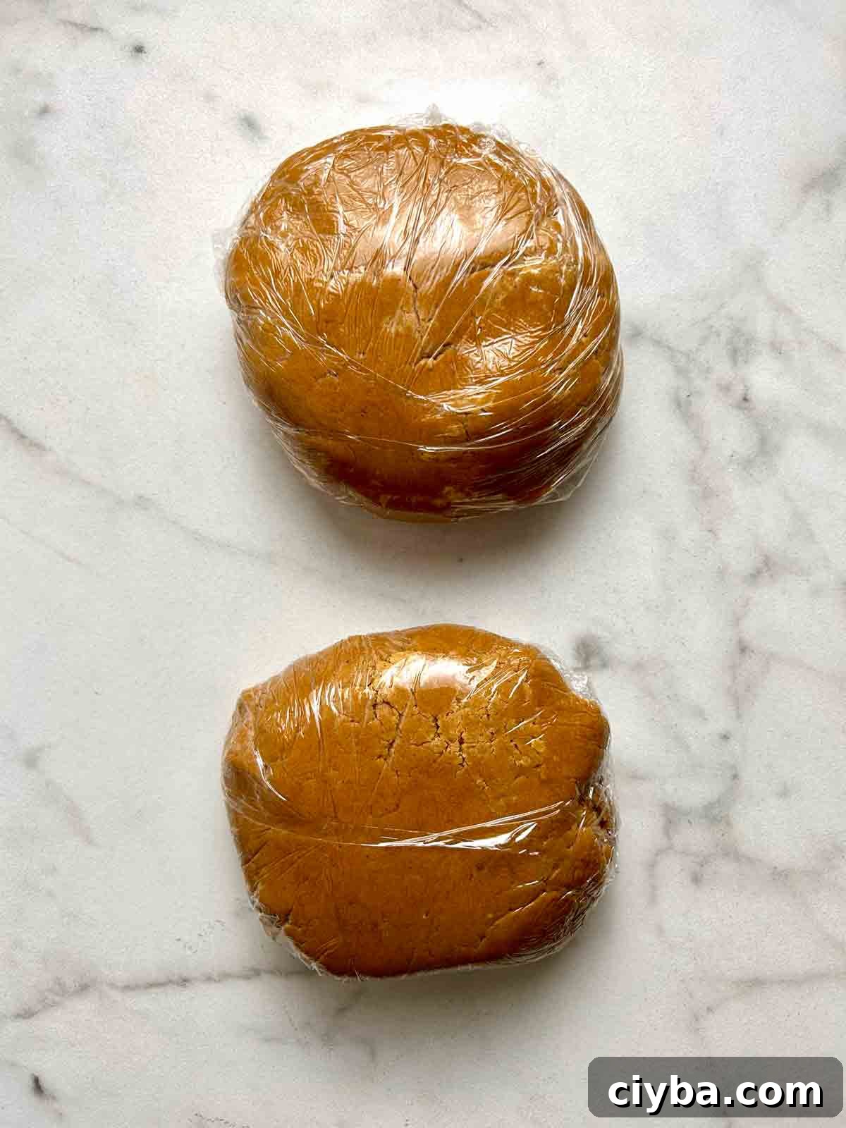 Classic Gingerbread Cookies Recipe for Soft, Spiced Cookies 7 dough divided into two balls and wrapped in plastic.
