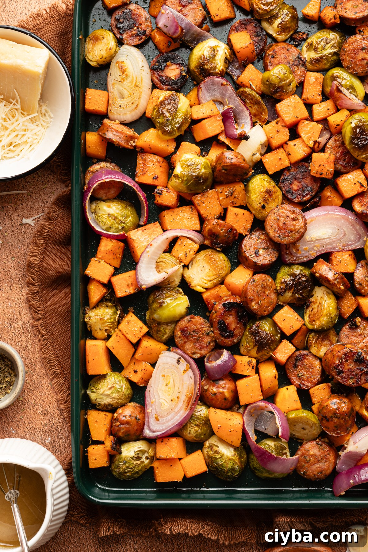 A close up photo of an Autumn sheet pan dinner with chicken sausage and roasted fall veggies