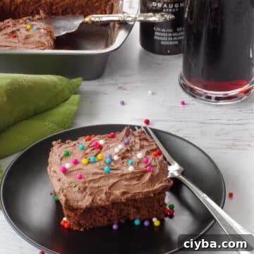 10 Irresistible Baileys Dessert Recipes for St. Patrick’s Day 11 a piece of chocolate guinness cake on a black plate with a pan with more in the background