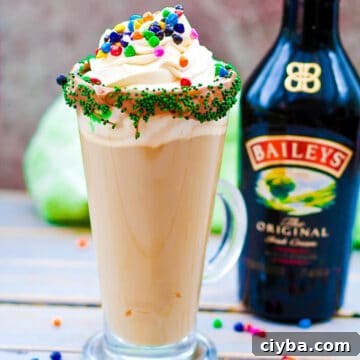 10 Irresistible Baileys Dessert Recipes for St. Patrick’s Day 9 Mint Irish Latte on wooden surface with Bottle of Baileys in the background