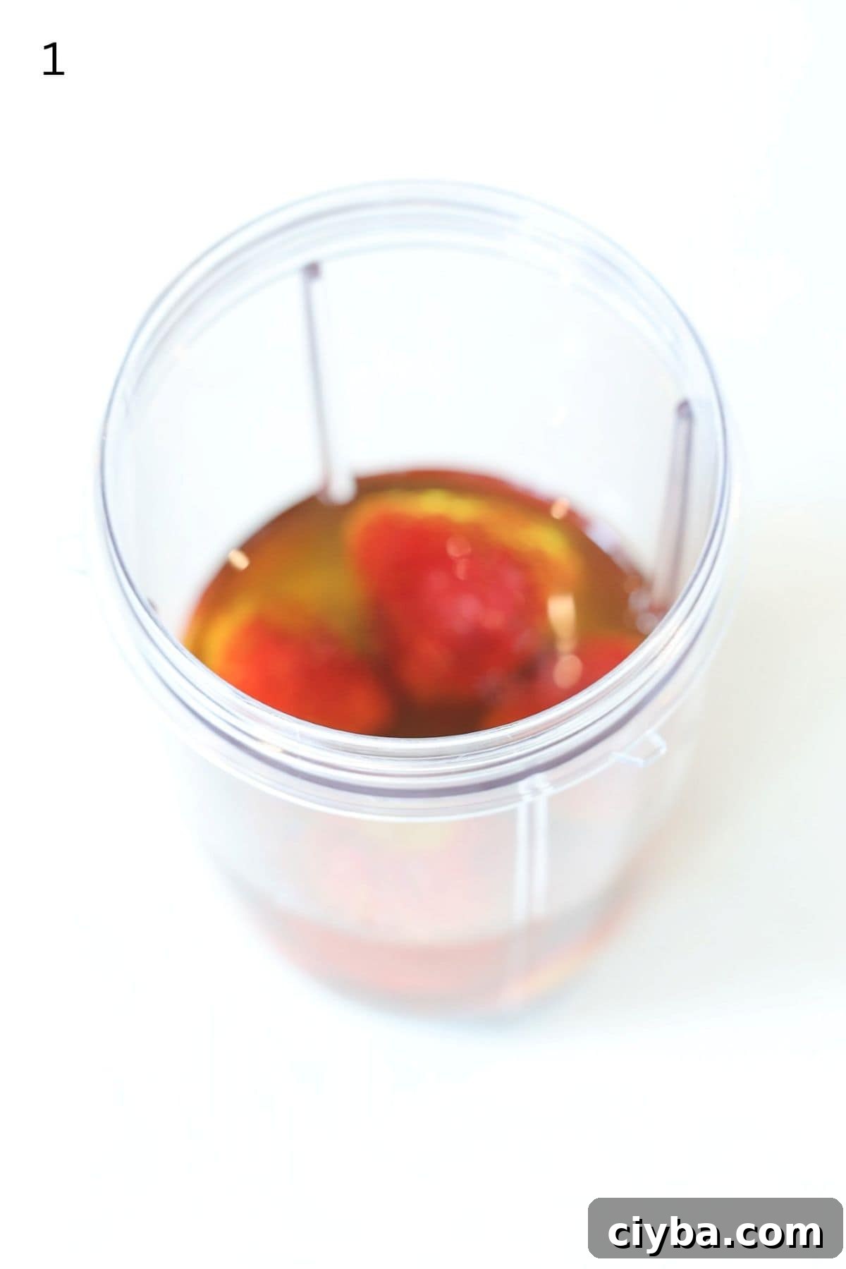 Strawberry salad dressing ingredients in a Nutri bullet blender container.