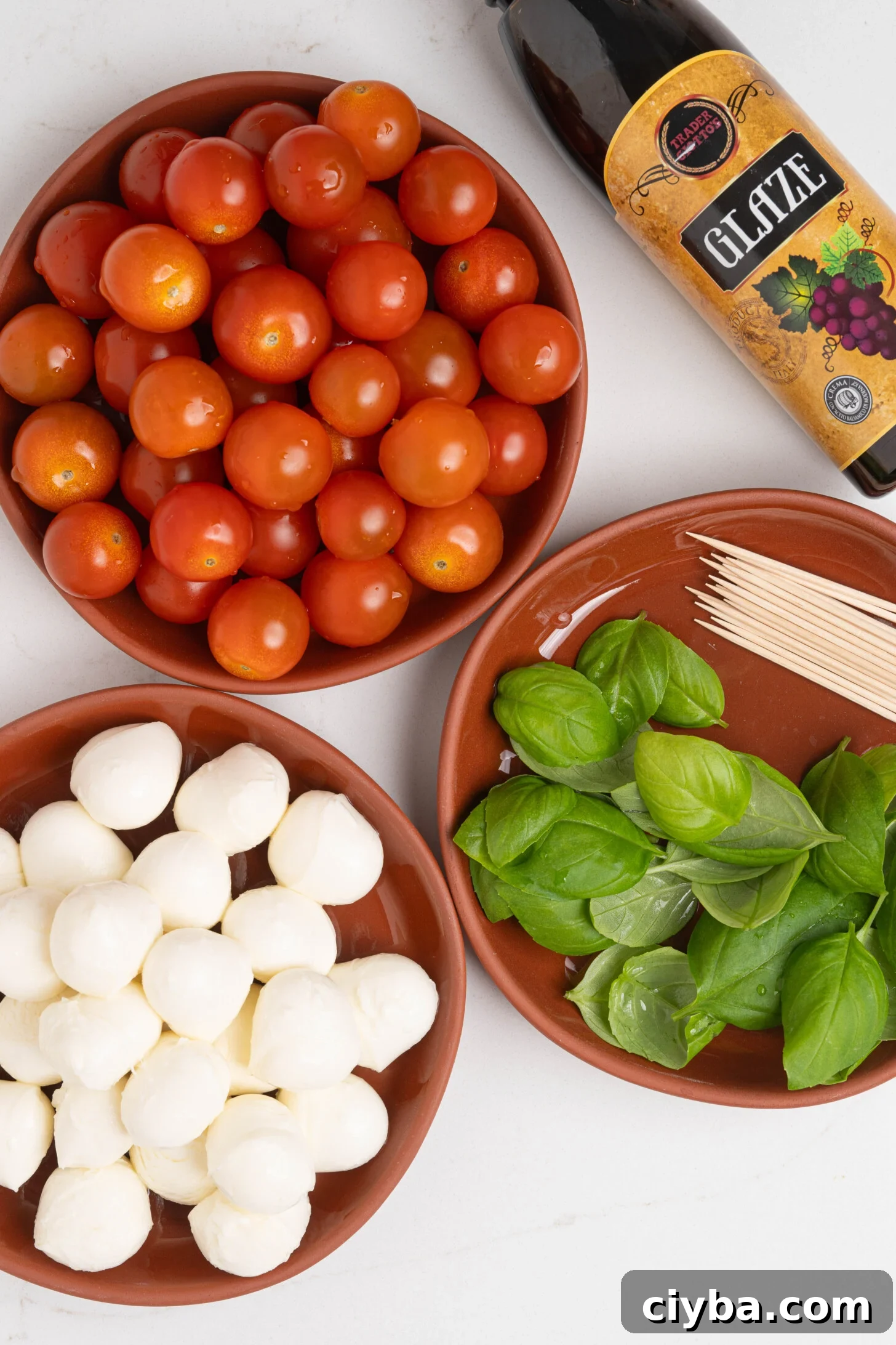 Caprese Skewers with Balsamic Glaze — Tomato, Mozzarella & Basil 4 Bowls of tomatoes, mozzarella, and basil.