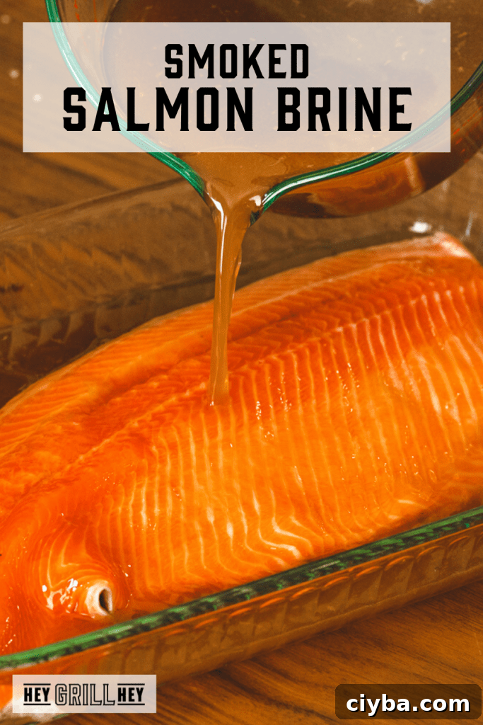 Salmon brine being poured over a large salmon filet with text overlay - Smoked Salmon Brine.