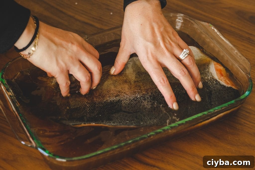 Salmon being added to smoked salmon brine.