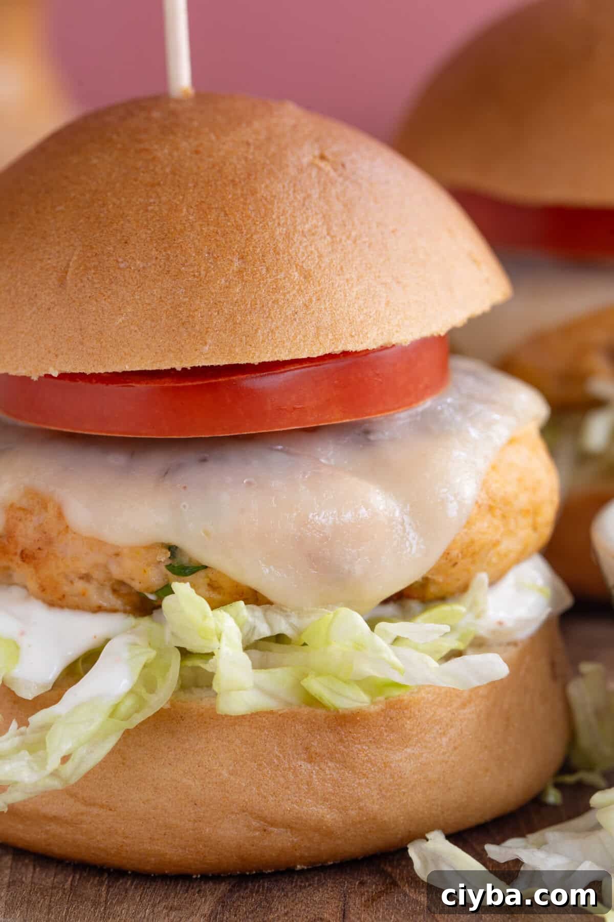 A finished chicken burger in a bun.