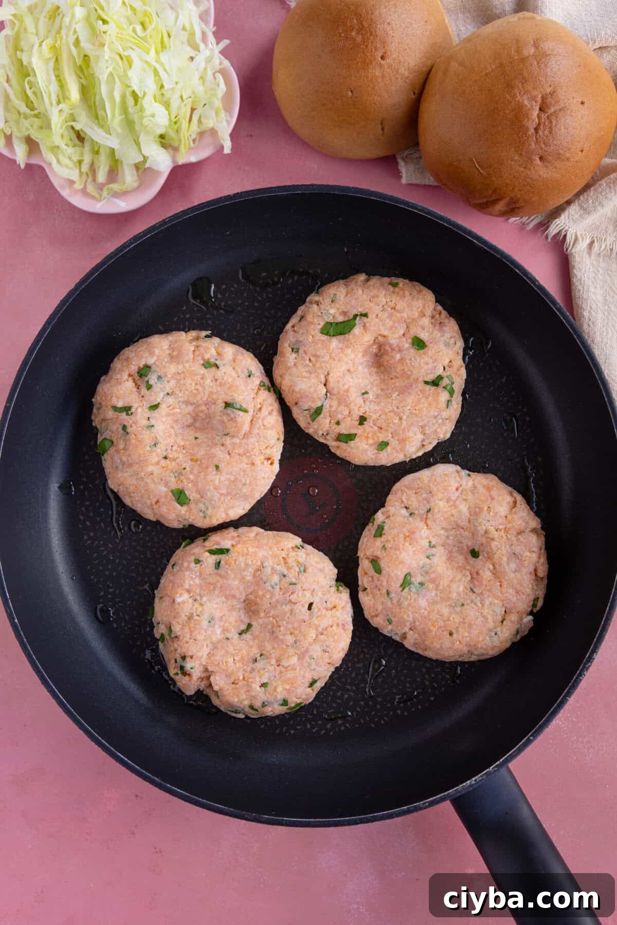 Process shot for chicken mince burgers showing the mixture in a pan.