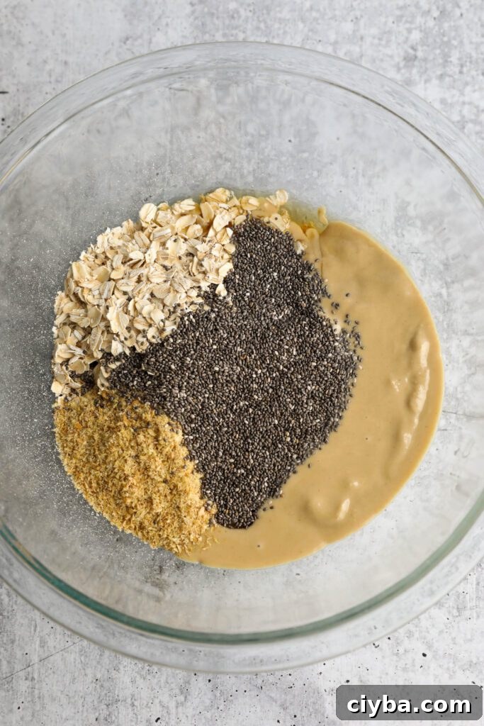 oats, tahini, ground flaxseed, and chia seeds in mixing bowl 
