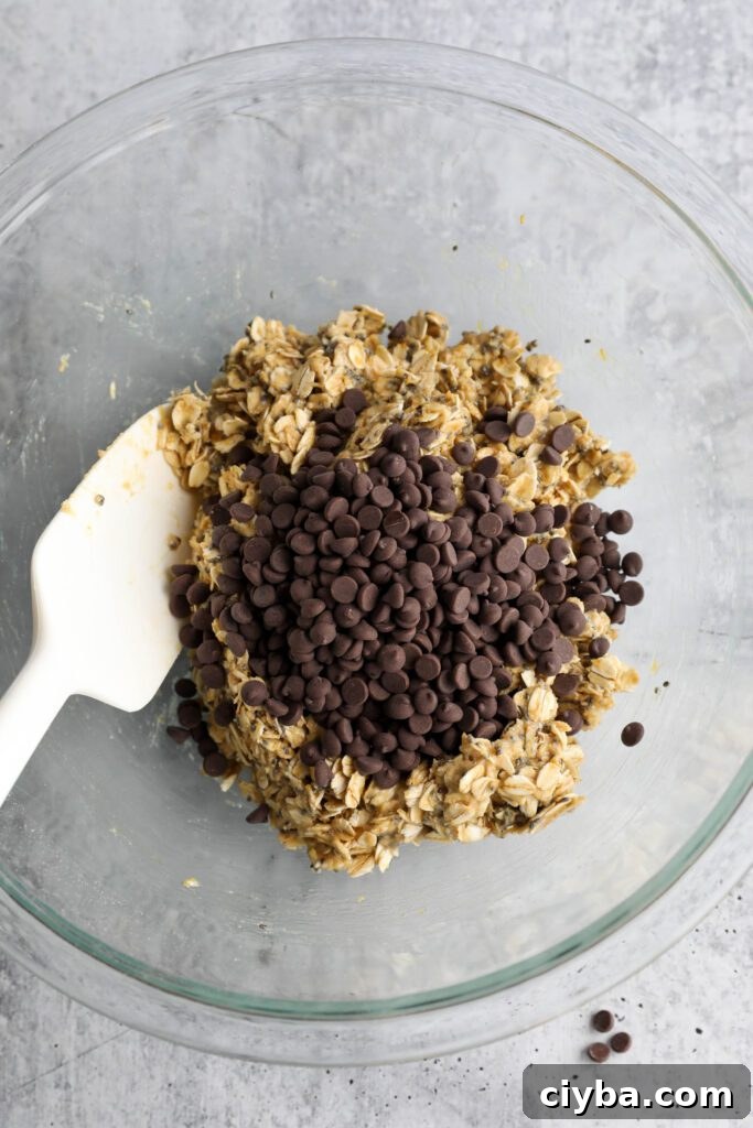 Tahini Chocolate Chip Bliss Ball dough with chocolate chips mixed in plus spatula