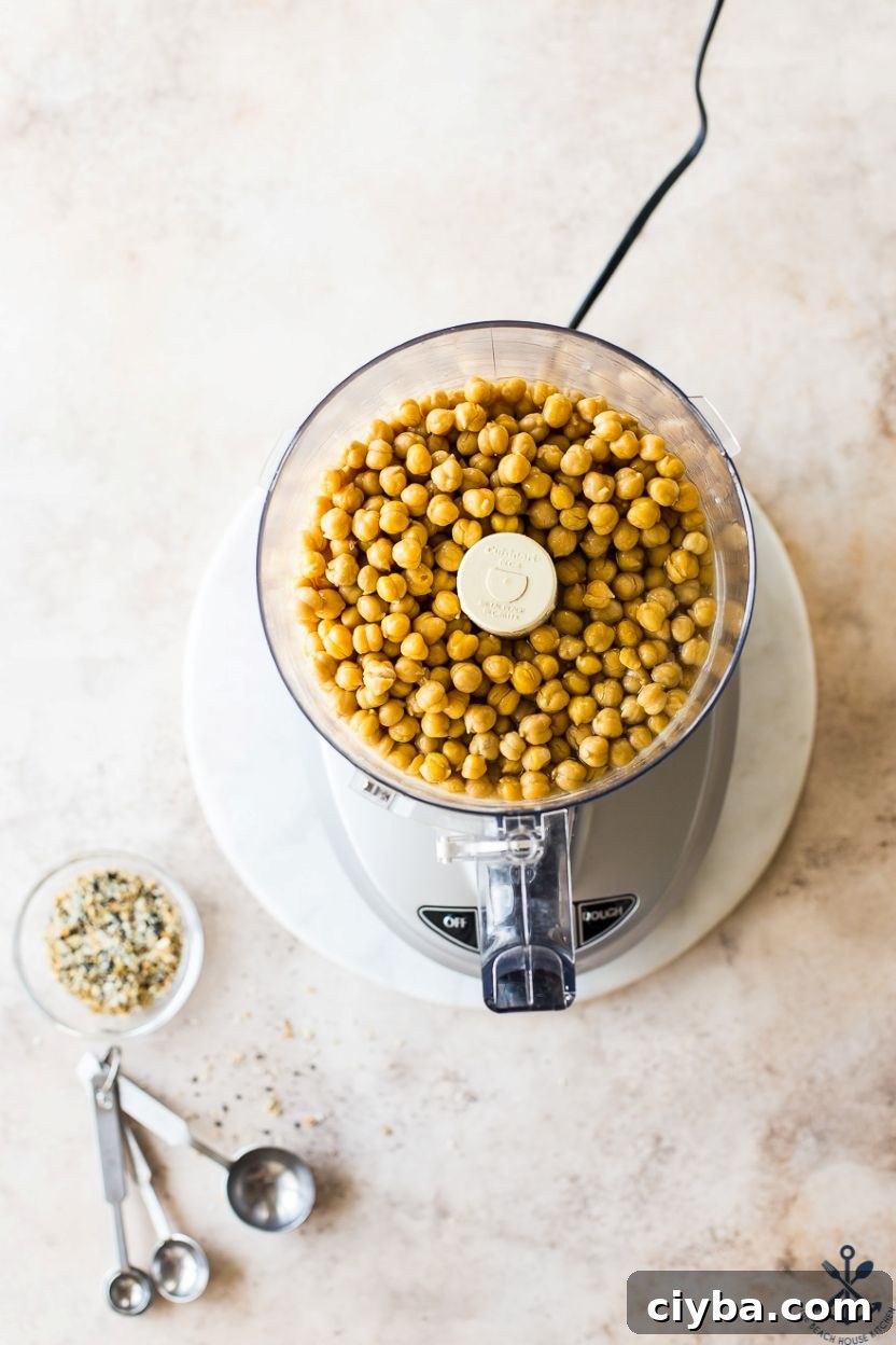 Overhead photo of a food processor filled with chickpeas
