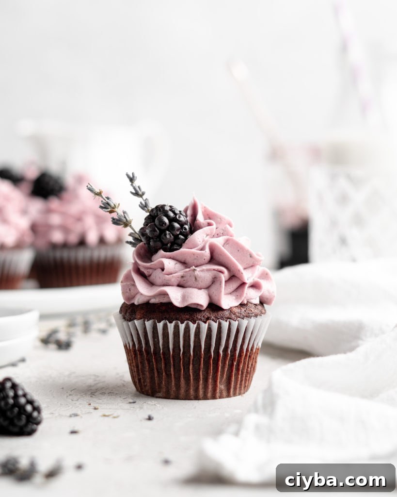 quick and easy chocolate cupcakes are topped with a creamy lavender blackberry buttercream frosting