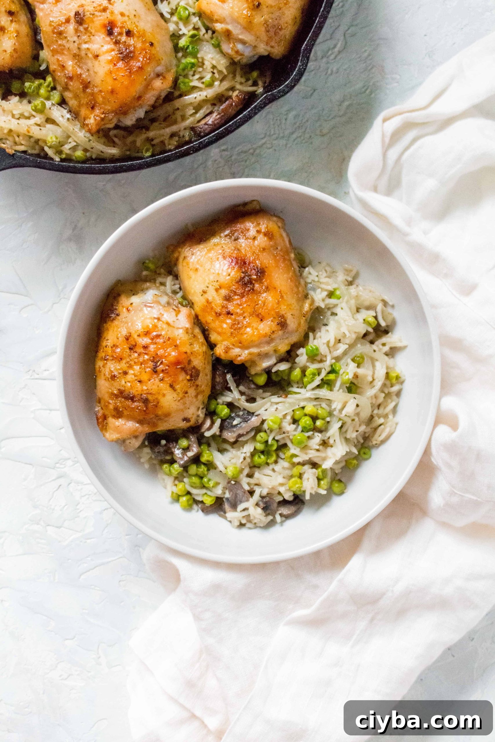 Grab your cast iron and make this one pot crispy and juicy chicken thighs with mushroom, onions, and pea rice tonight!