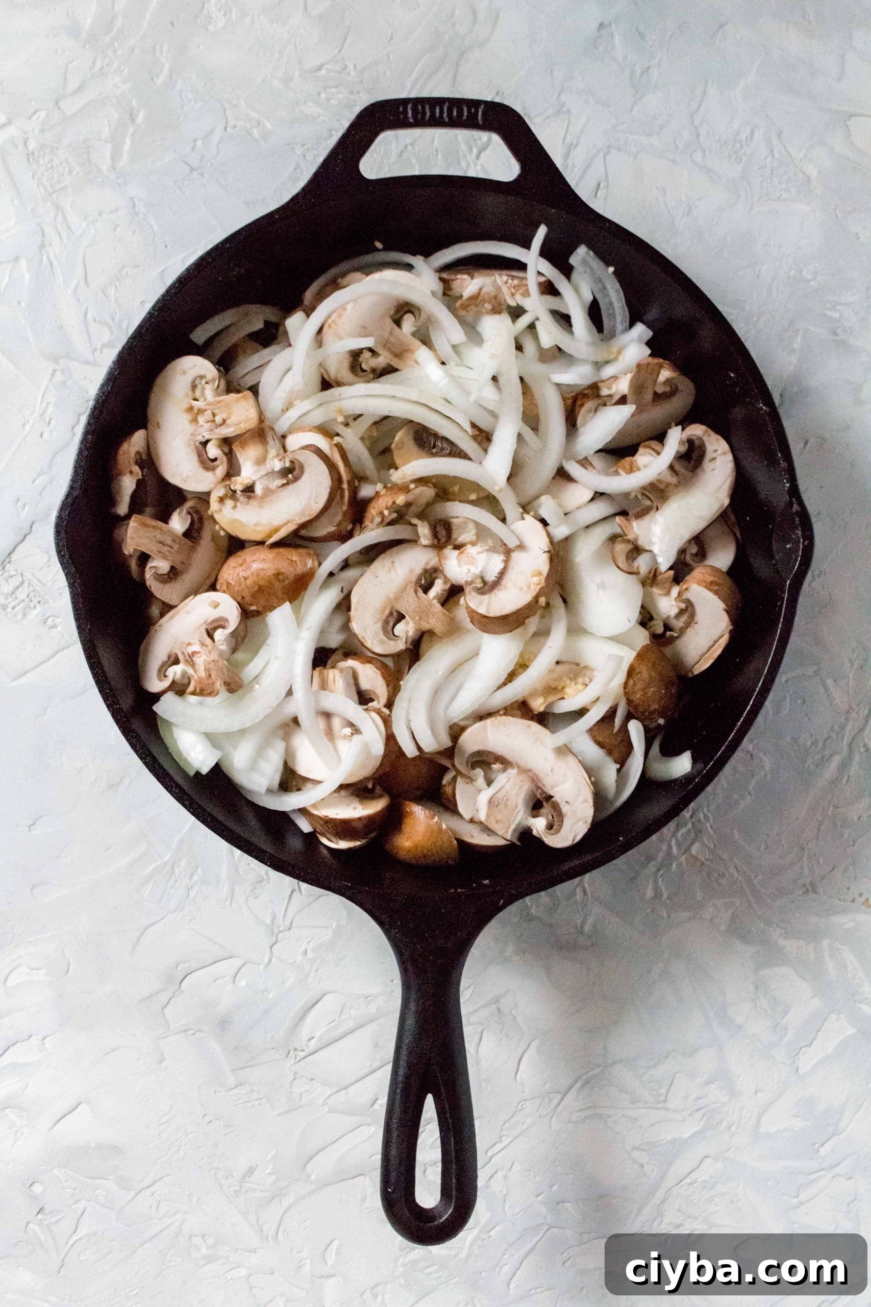 one pot chicken thighs and rice: Back in the cast iron, sauté the mushrooms, onions, and garlic, using the liquid from the olive oil and chicken, for 5 minutes.