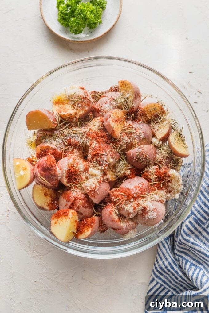 Crispy Parmesan-Crusted Red Potatoes for Dinner 5 Baby potatoes tossed with olive oil, Parmesan, and herbs in a prep bowl.