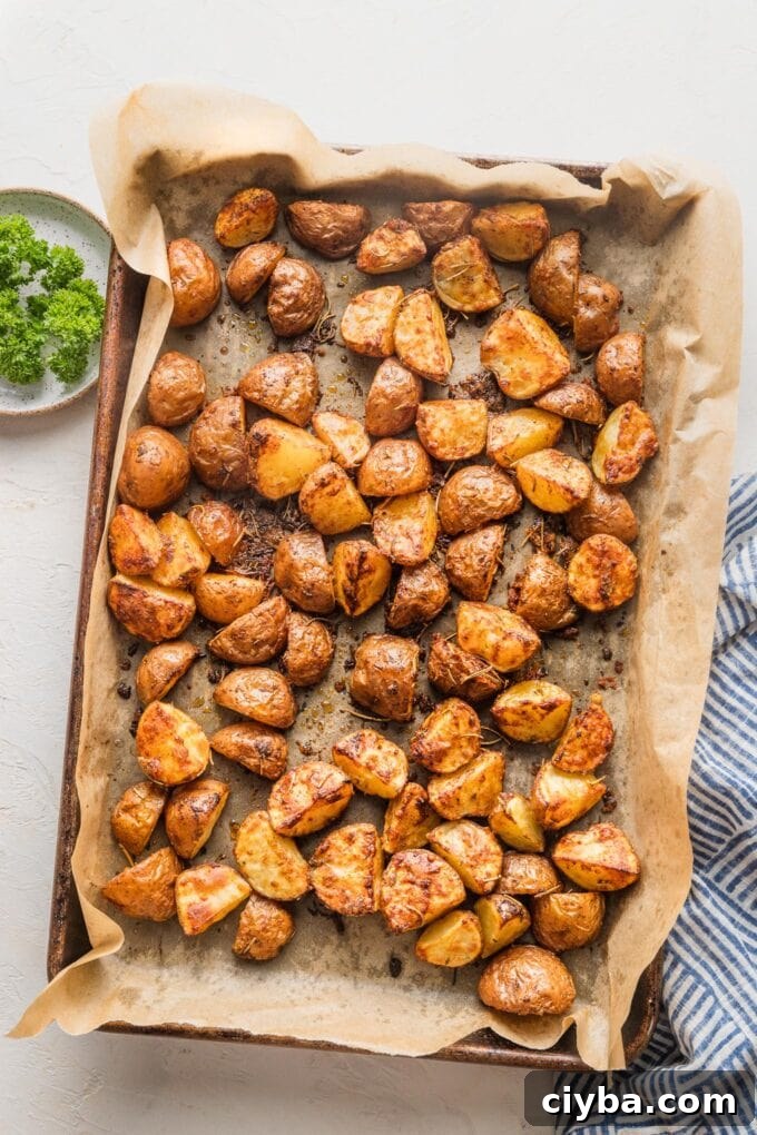 Crispy Parmesan-Crusted Red Potatoes for Dinner 7 Baking sheet full of Parmesan roasted red potatoes.