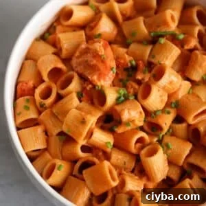 lobster pasta in a white bowl.