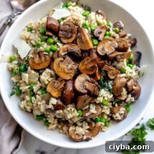 An overhead image of mushroom pea risotto in a bowl.