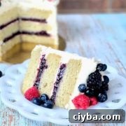 slice of vanilla cake with berry filling