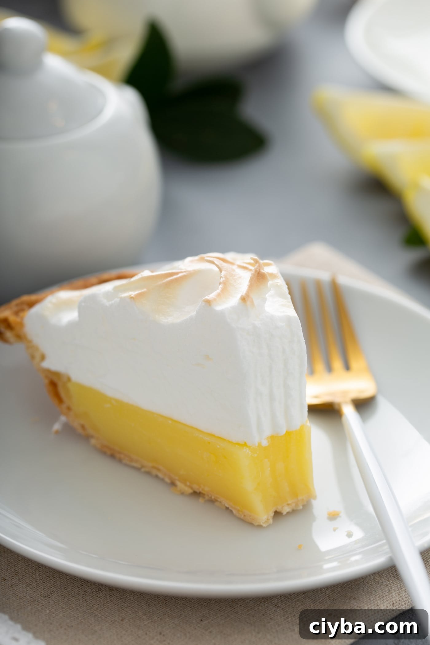 A slice of lemon meringue pie with a bite taken