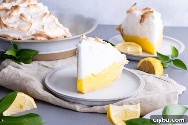 A slice of lemon meringue pie on a white plate