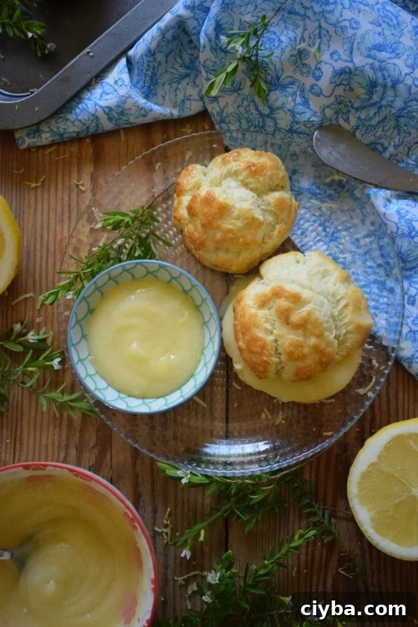lemon curd filled scones on a plate with lemons