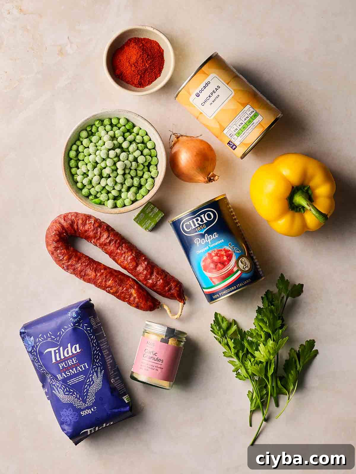 One-Pan Chorizo and Rice Bake: Dump, Bake, Serve 4 The ingredients for making a dump and bake recipe, Chorizo Rice, all laid out on a white surface.