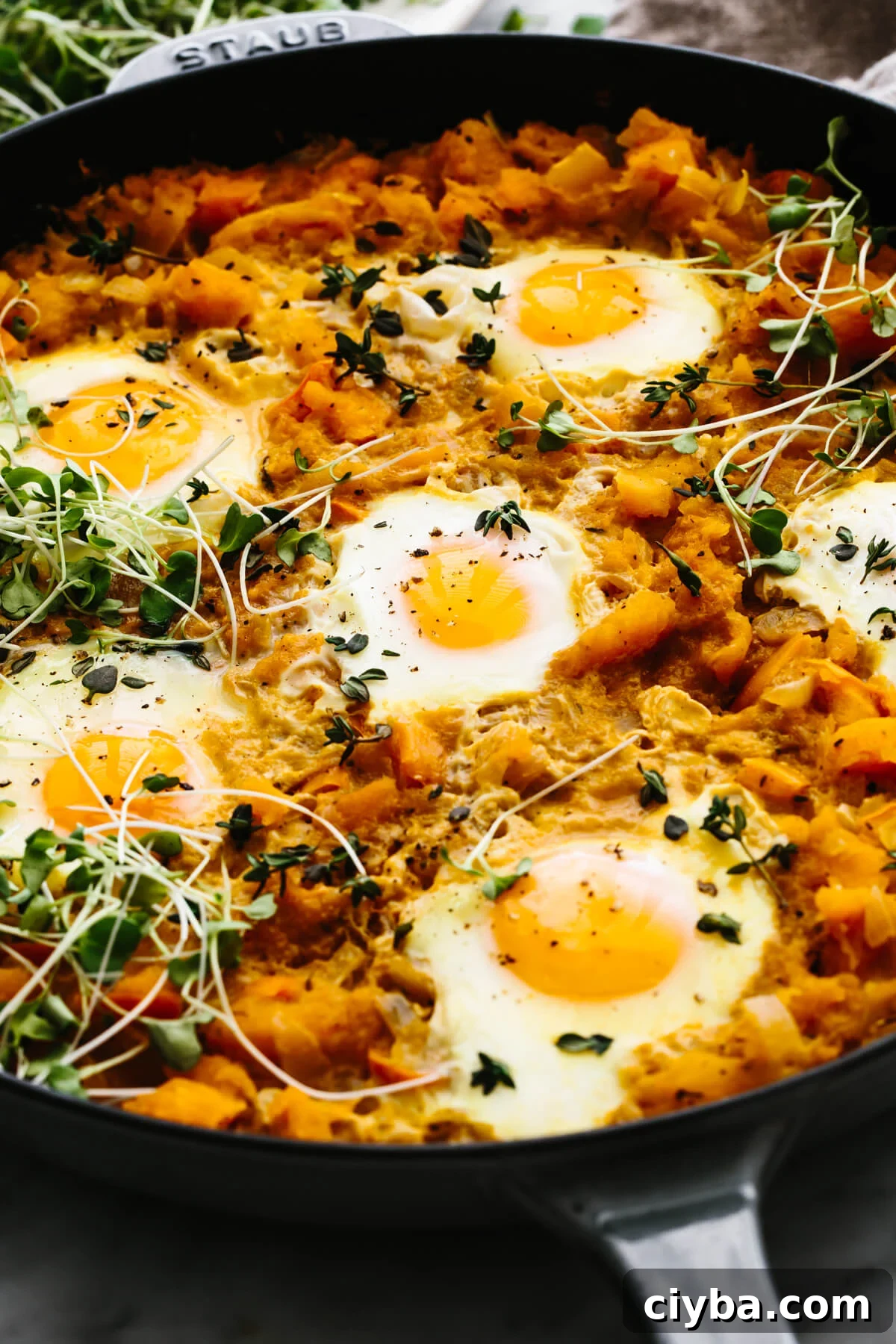 A skillet with orange shakshuka.