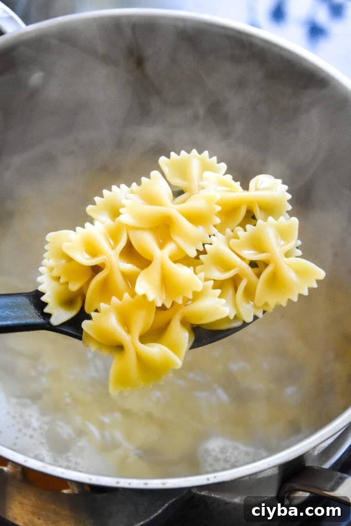cooked bowtie pasta on a spoon.
