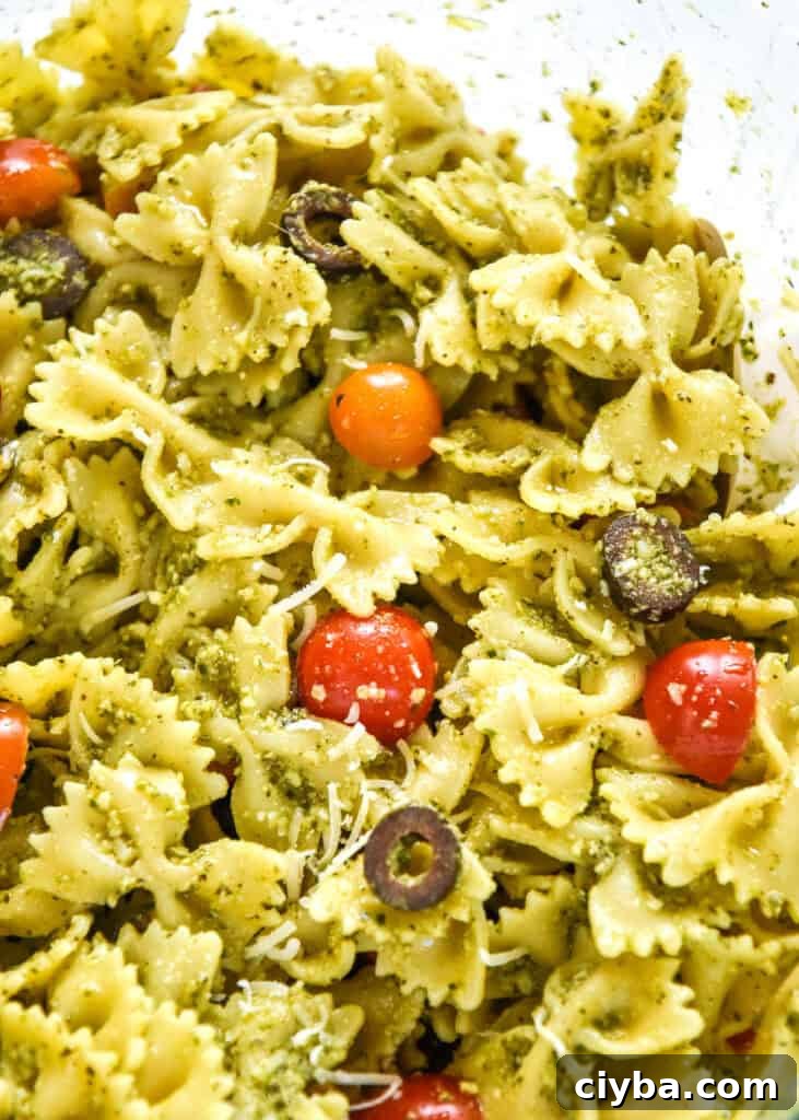 easy pesto pasta salad mixed up in a large bowl.