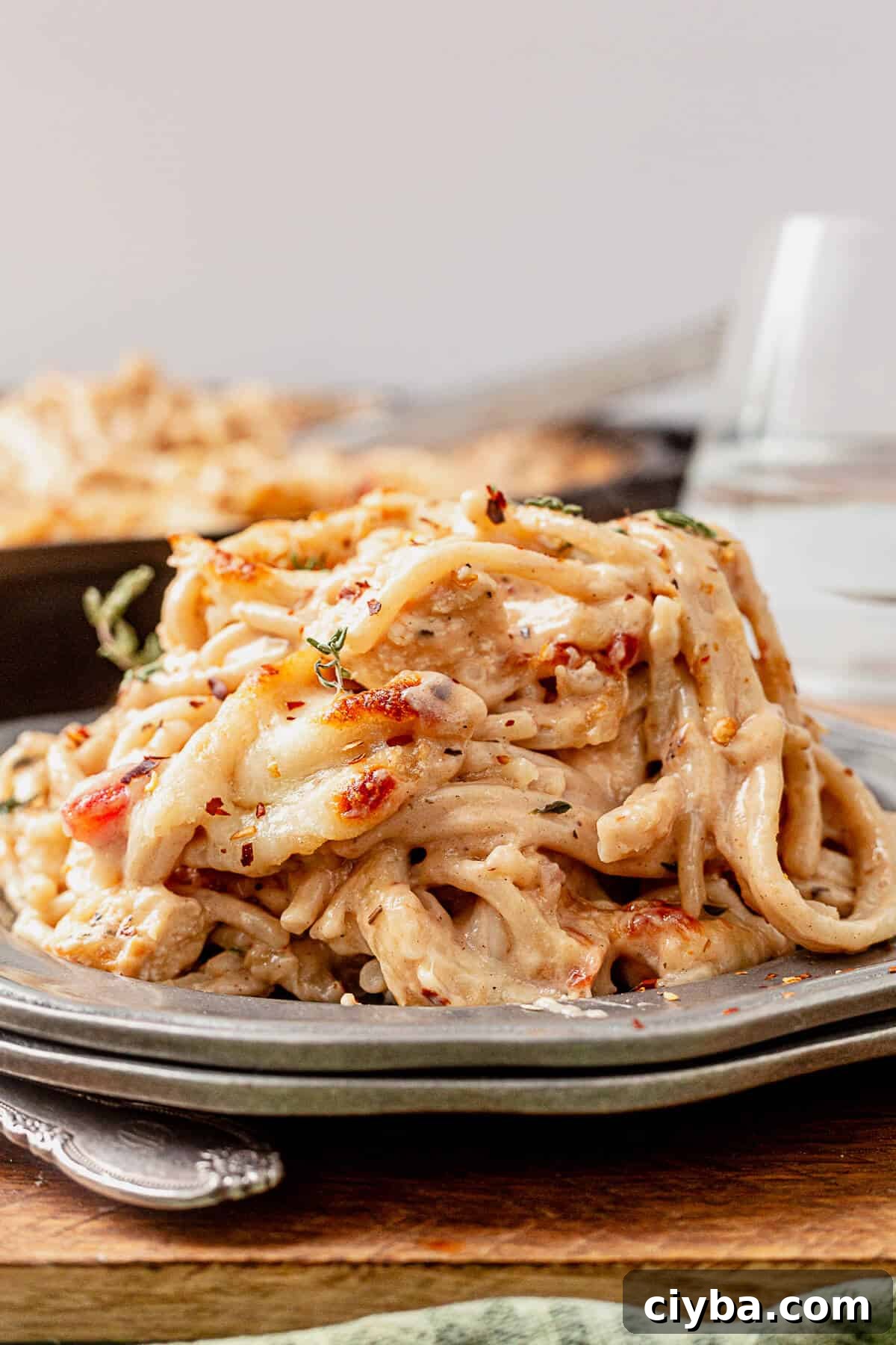 a pile of spaghetti chicken on a plate