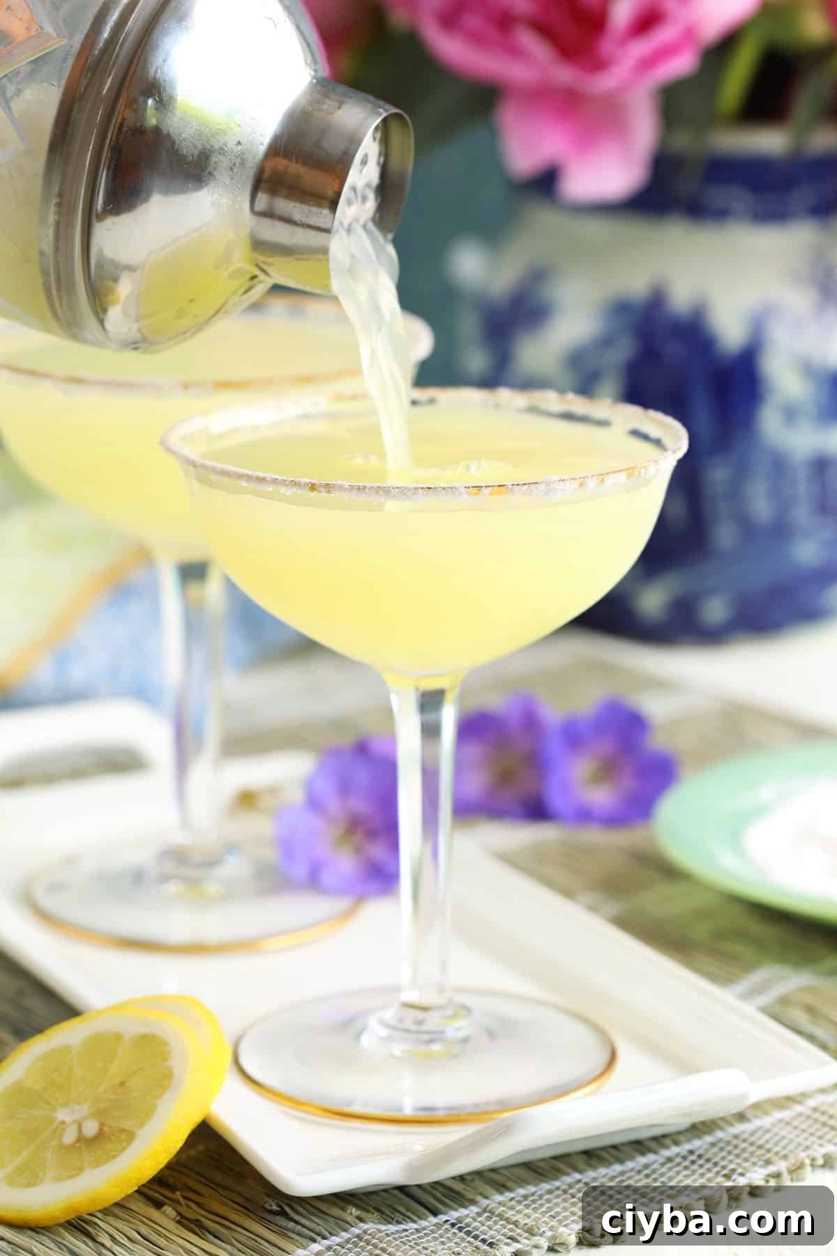 A martini is being poured into a glass. 